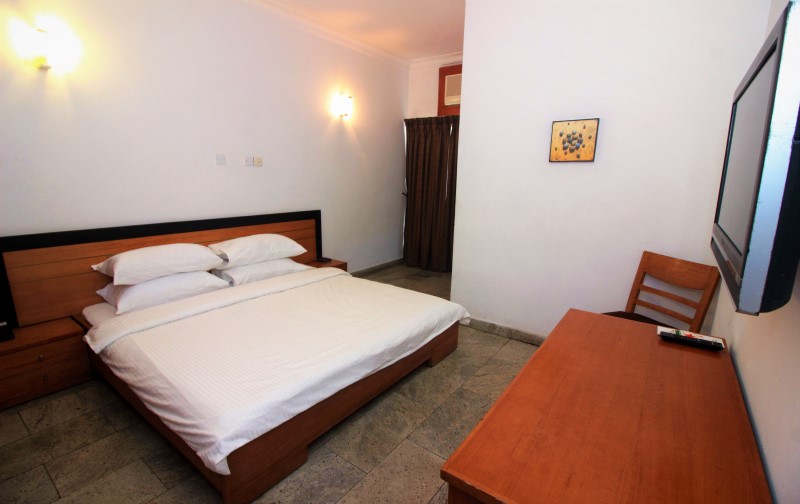 Facilities includes; a flat screen TV, an Ac,  a side chair and a Bedside table.